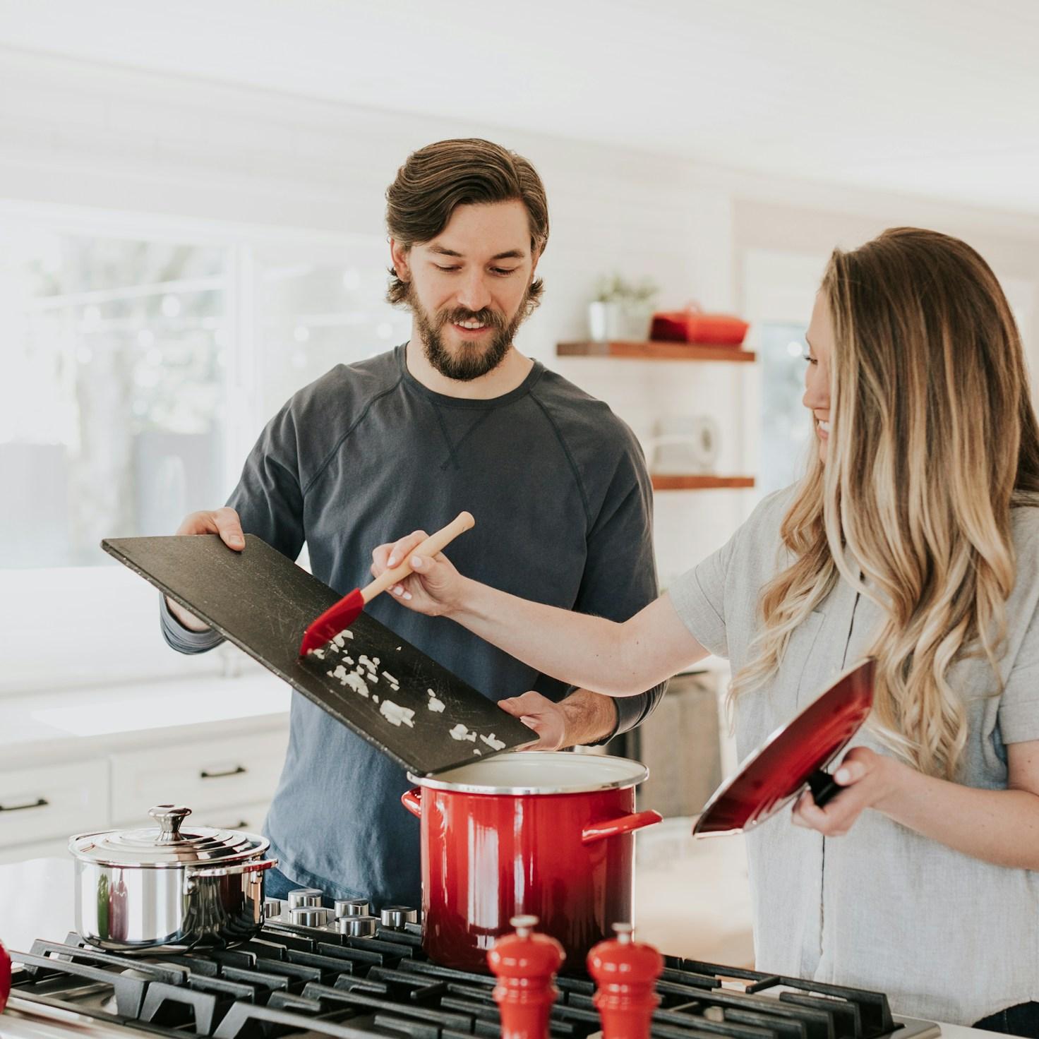 Community members collaborating in a contemporary kitchen, sharing recipes and techniques