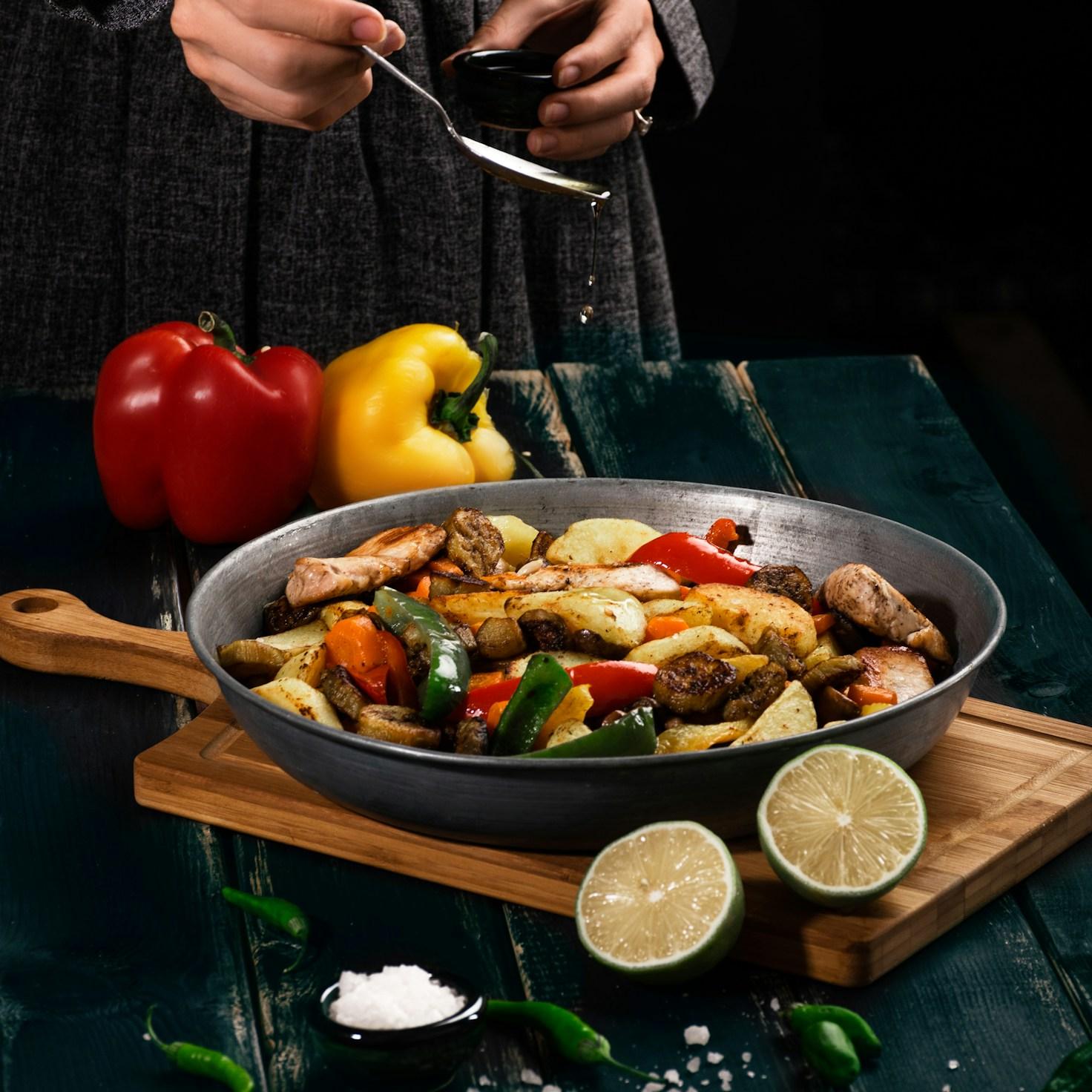 Diverse group of community members sharing a meal together, highlighting the social bonds formed through collaborative cooking